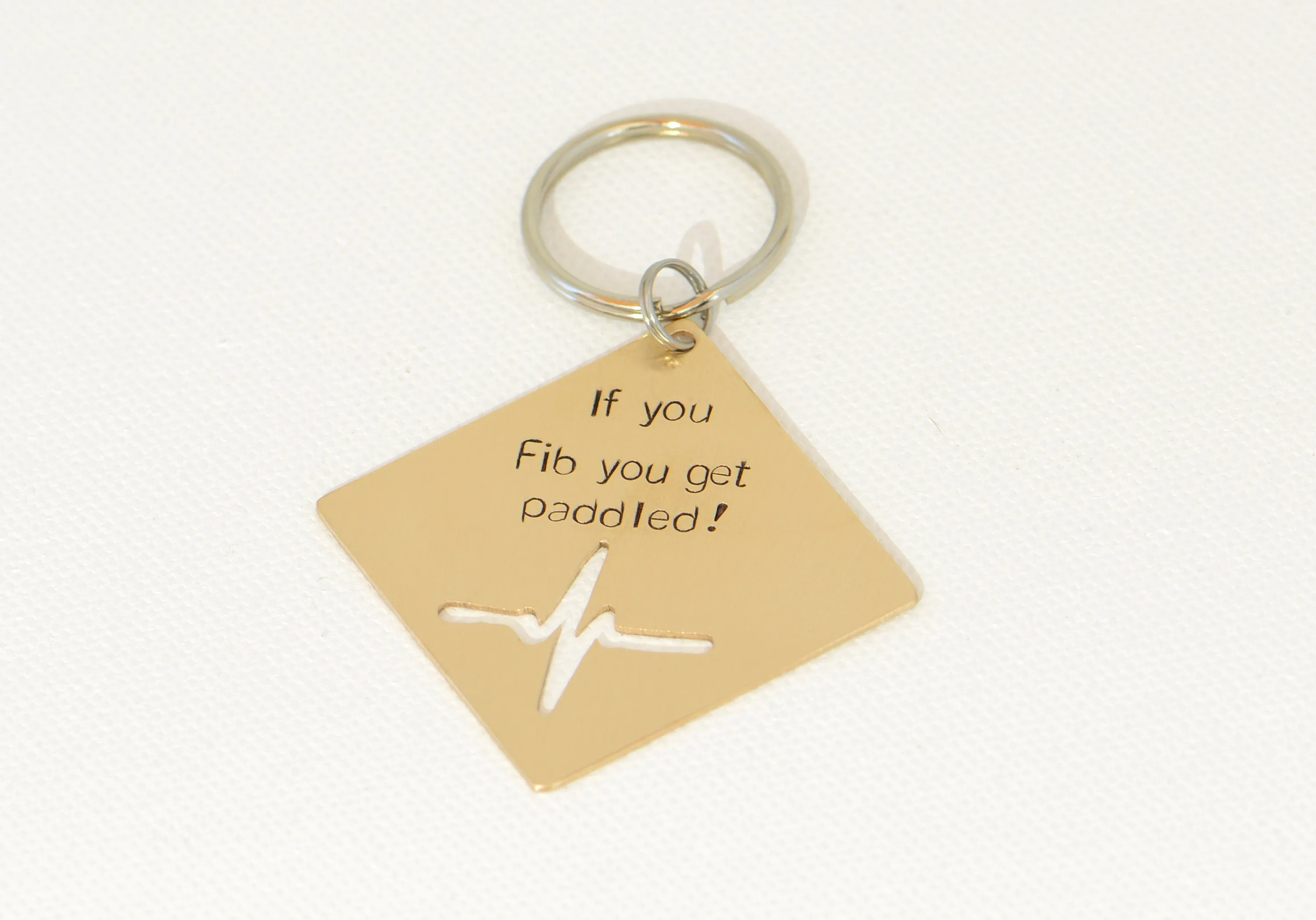 If you Fib you get paddled bronze key chain with heartbeat